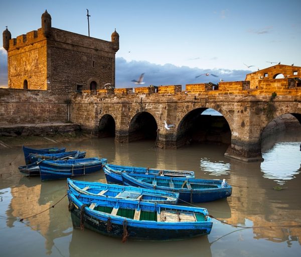 Fishing boats and historical bastion in Essaouira, Morocco.